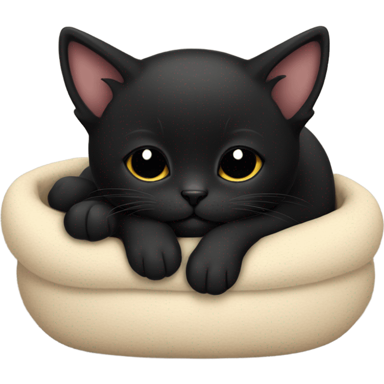 Black kitten sleeping in a bed emoji