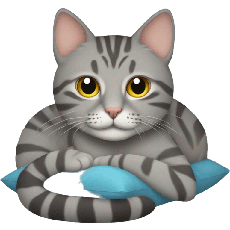 A grey tabby cat lies with its head on a pillow emoji