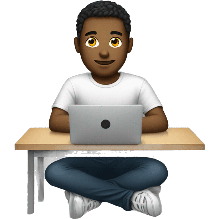 a young man is sitting at a laptop in a T-shirt emoji