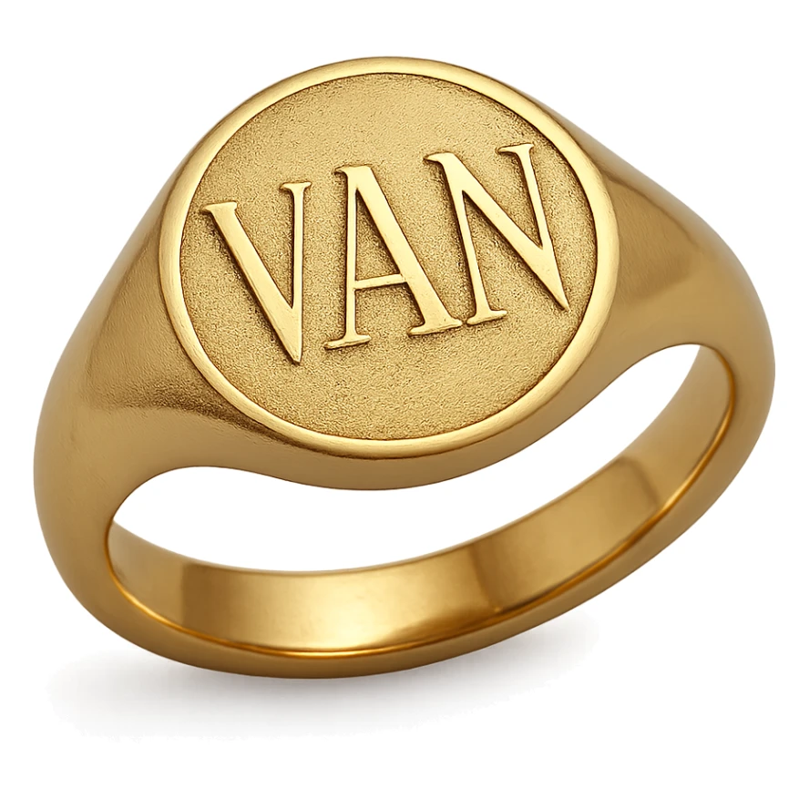 a gold ring with the letters V, A, and N engraved sticker