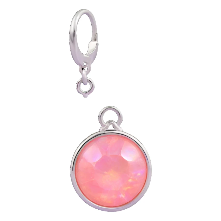 extreme macro of a round cut pink fire opal charm with silver setting and silver jump ring, glossy and iridescent finish sticker