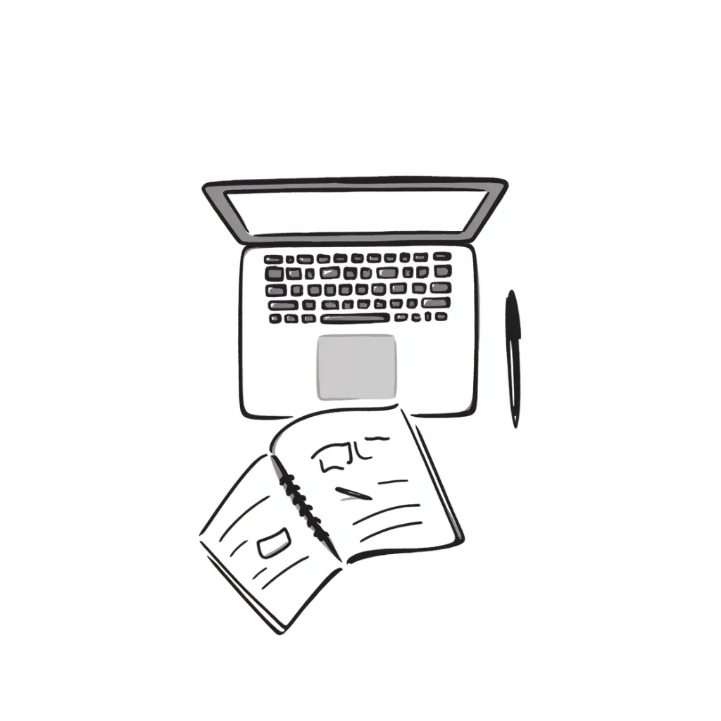 top view of a MacBook and a notebook with a pen nearby, notebook with visible notes sticker