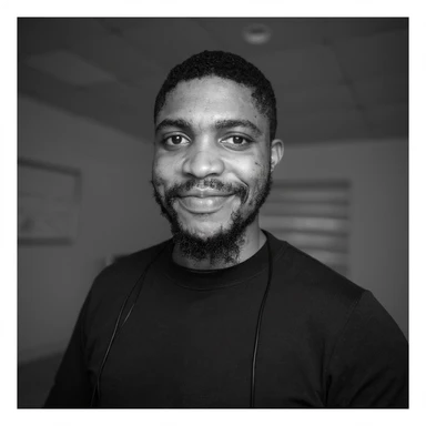 A professional portrait of me in monochrome. Plain black crew neck shirt. Tailored to LinkedIn. Tech boy vibe (programmer). I’m a black man from Nigeria. Retain facial features from attached image. Smooth skin. No accessories. sticker