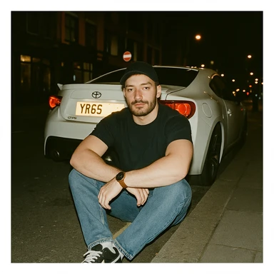 Grunge-style analog photo, London 2025, person inspired by the new reference image sitting on the curb in front of a Nissan GT 86, model pose, black t-shirt, jeans, Nike Air Jordan low, using flash, city street, analog grain, 5/8. sticker