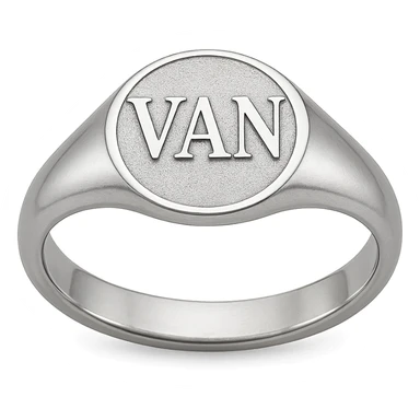 a silver ring with the letters V, A, and N engraved sticker