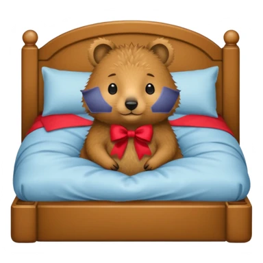 Quokka in a bed with a bow sticker