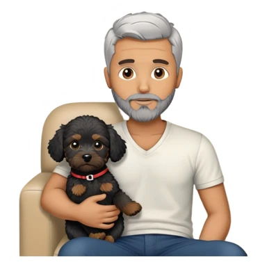 34 year old man with short straight grey hair and beard with A black cavapoo puppy with a white chest on the sofa sticker