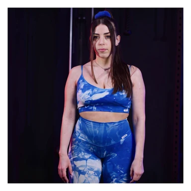 Realistic style image of a woman in sportswear inspired by the two reference photos, showing water retention on the legs with localized swelling on calves and ankles. Clear anatomical details, front view, neutral background, medical realistic appearance. sticker