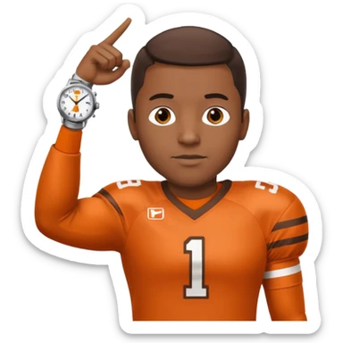 Black man in a brown and orange football jersey holding up his left arm with a watch on, pointing at the watch with his right hand sticker