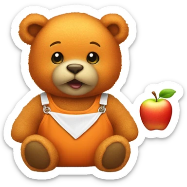 Small orange teddy bear wearing a bib with an apple on  sticker