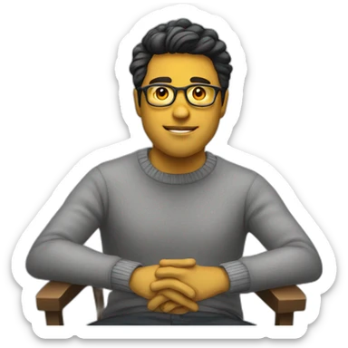 White man with yellow tinted glasses and black hair in a gray jumper and sitting on a chair sticker