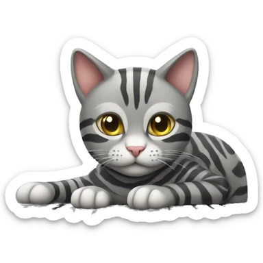A striped grey cat is lying on the keyboard of the computer sticker