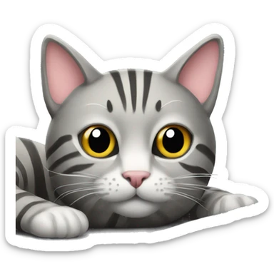 A striped grey cat is lying on the keyboard of the computer sticker