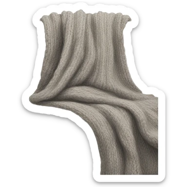 A soft beige sofa with a chunky gray knit throw draped over it sticker