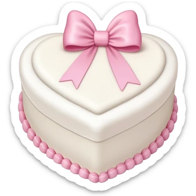 white heart shaped birthday cake with pink bow sticker