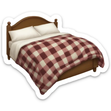 A comfy bed with a plaid throw draped over it and a white pillow sticker