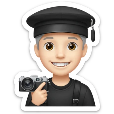 smiling schoolboy with large front teeth wearing a black cap holding a camera sticker