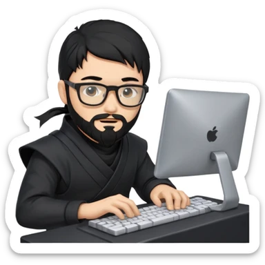 Man with black hair and beard wearing glasses in a ninja costume typing on a computer keyboard sticker