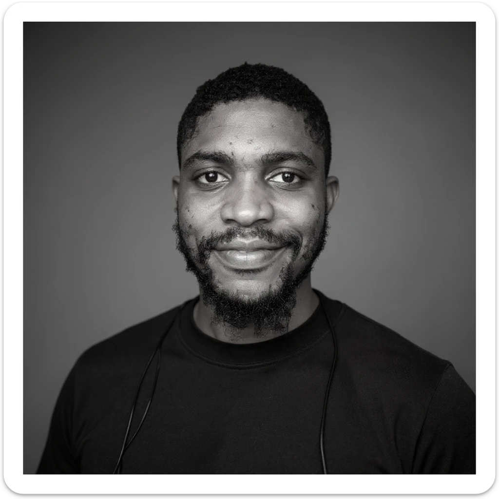 A professional portrait of me in monochrome. Plain black crew neck shirt. Tailored to LinkedIn. Tech boy vibe (programmer). I’m a black man from Nigeria. Retain facial features from attached image. Smooth skin. No accessories. sticker