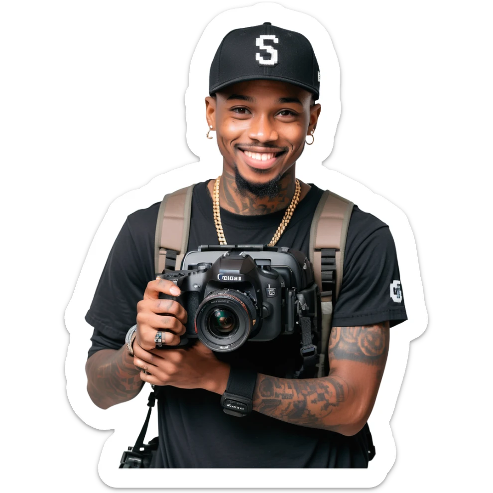 Young African cinematographer with tattoo-covered arms, wearing all black clothing and a baseball cap, holding a DSLR camera. Has dark brown eyes, a bright smile, and a small goatee. sticker