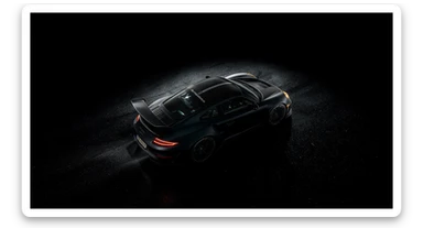 Editorial shot of a porsche 911 gt3 rs, top dutch angle, black voide around, top spotlight, captured on arri alexa sticker