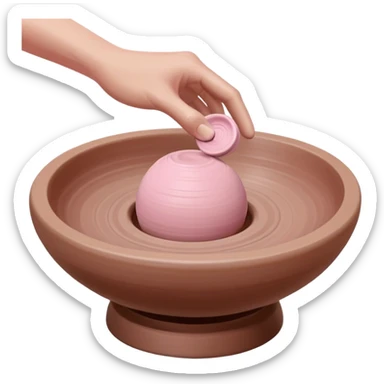 single hand throwing a pink ball of clay onto a pottery wheel, only one hand visible in the frame sticker