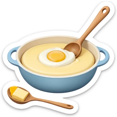 A cream ceramic baking bowl with a wooden spoon in it, next to it is a carton of eggs and butter sticker