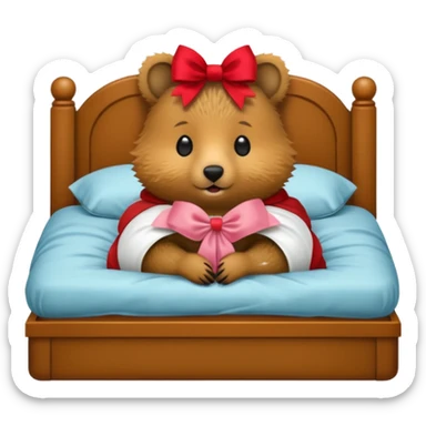 Quokka in a bed with a bow sticker