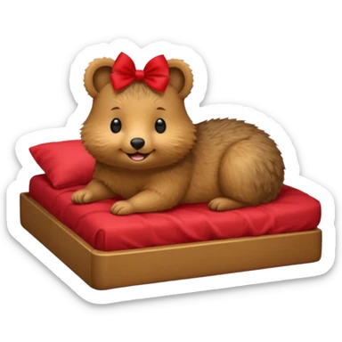 Quokka in a bed with a bow sticker
