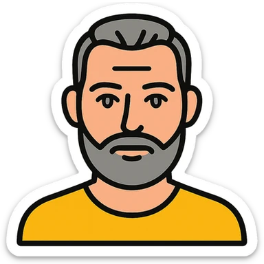 A middle-aged man with a medium slightly gray beard, short hair cut to the scalp on the sides and combed back on top, blue eyes sticker