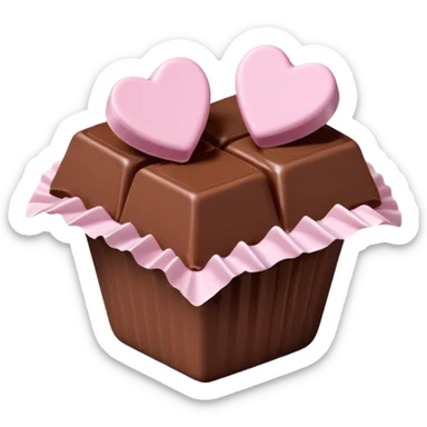 Two square milk chocolate , Each praline is a sharp-edged cube with smooth glossy chocolate coating, placed in a small white fluted paper candy cup. On top of each cube is a flat pastel pink heart-shaped icing sticker