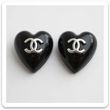 photorealistic heart-shaped Chanel earrings in black and white with a silver logo, elegant sticker