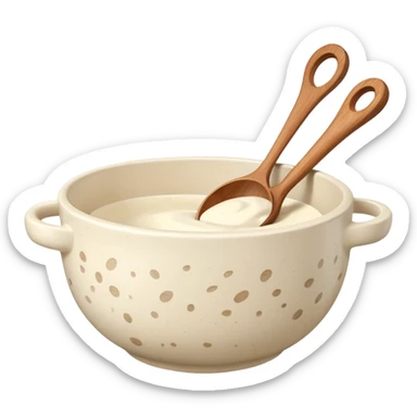 a cream ceramic mixing bowl with a wooden spoon stirring sticker