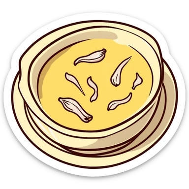 creamy alioli sauce in a small dish with garlic cloves nearby sticker