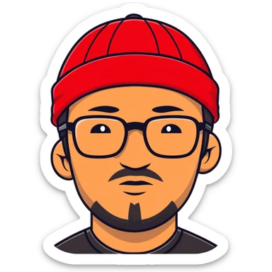 Asian man with black goatee, glasses, wearing a small red beanie sticker