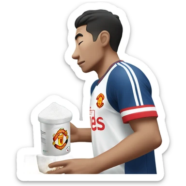 Korean man sniffing white powdered sugar. He’s wearing a Manchester United jersey sticker