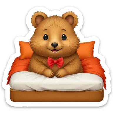 Quokka in a bed with a bow sticker
