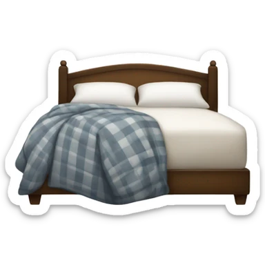A comfy bed with a plaid throw draped over it and a white pillow sticker