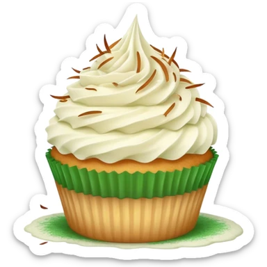 Vanilla cupcake with vanilla frosting with toasted coconut on top and green dust sticker