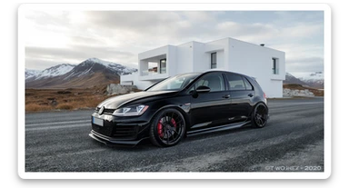 black Golf A4 with bodykit, in background is modern huge two flors white villa, in distance are iceland mountains, rule of thirds, shot on gopro hero, noise camera sticker