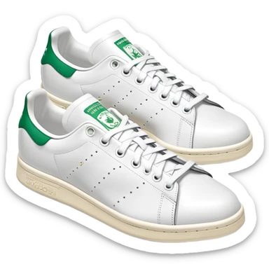 A pair of white Adidas Stan Smith sneakers arranged with one shoe behind the other, white leather with green heel tabs, classic design, both shoes visible sticker
