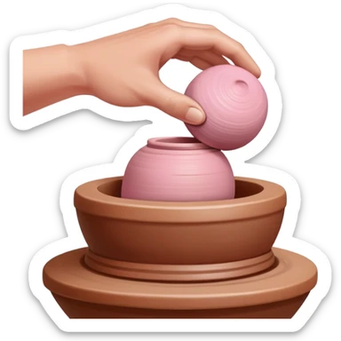 one hand throwing a pink ball of clay onto a completely empty pottery wheel with no pottery or other clay on it sticker