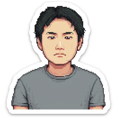 Asian man in a gray shirt with a frown sticker