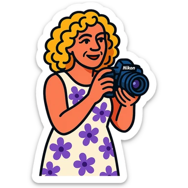 mujer rubia de rulos de 50 años con cámara Nikon y vestido largo blanco con flores lilas, estilo vibrant-toon sticker