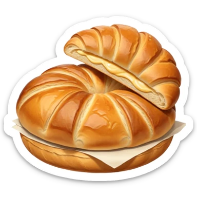 meat.A group of baked goods: a round bread roll beside a small croissant on a warm golden background. sticker