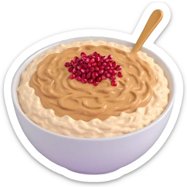 bowl of creamy oatmeal topped with swirls of peanut butter, shredded coconut, and ruby red pomegranate seeds sticker