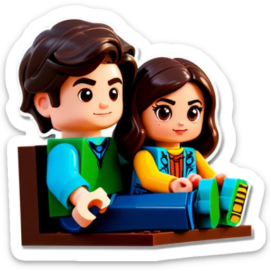A handsome young man with dark hair, a little heavy sits with his girlfriend with cascading, dark brown hair, flowing down her face as they sit together playing Legos sticker