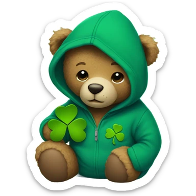 
A teddy bear wears a blue hoodie and holds a shamrock sticker