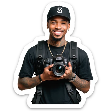 Young African cinematographer with tattoo-covered arms, wearing all black clothing and a baseball cap, holding a DSLR camera. Has dark brown eyes, a bright smile, and a small goatee. sticker
