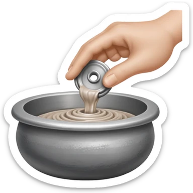 single hand scooping a blob of clay on a silver pottery wheel sticker